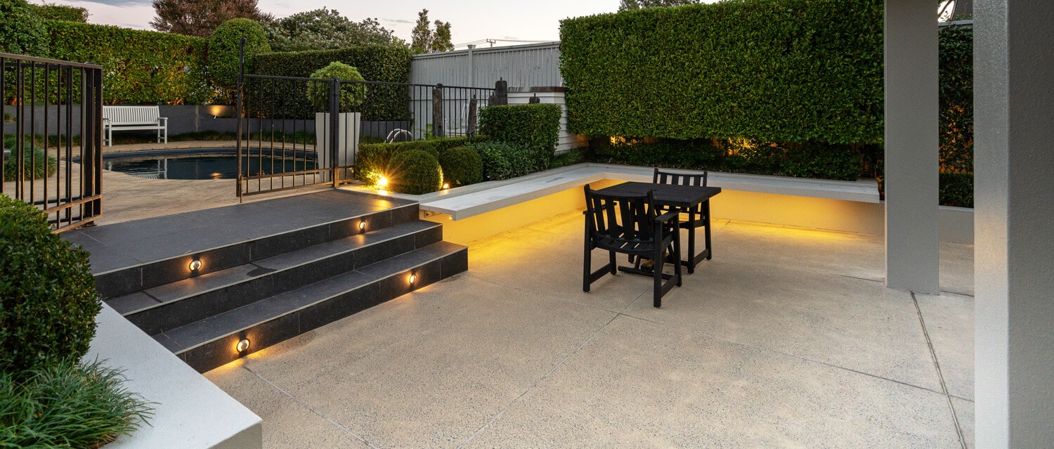 coloured-concrete-pool-surrounds-17 coloured concrete patio and pool surround with lights on stairs