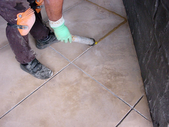 concrete-grout-gun Grout being applied with a PFL grout gun.
