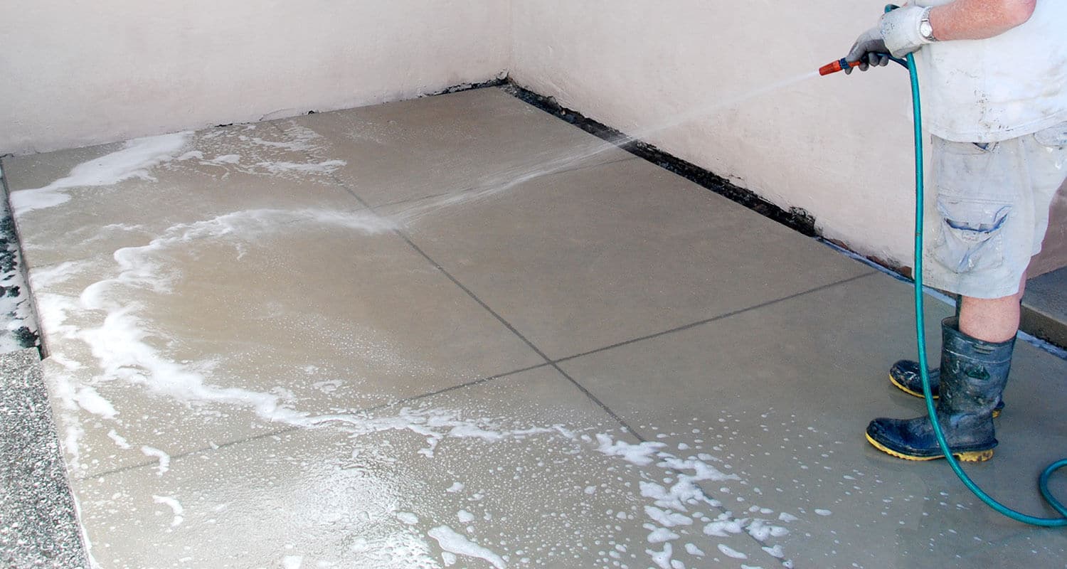 man preparing concrete for sealing step 5