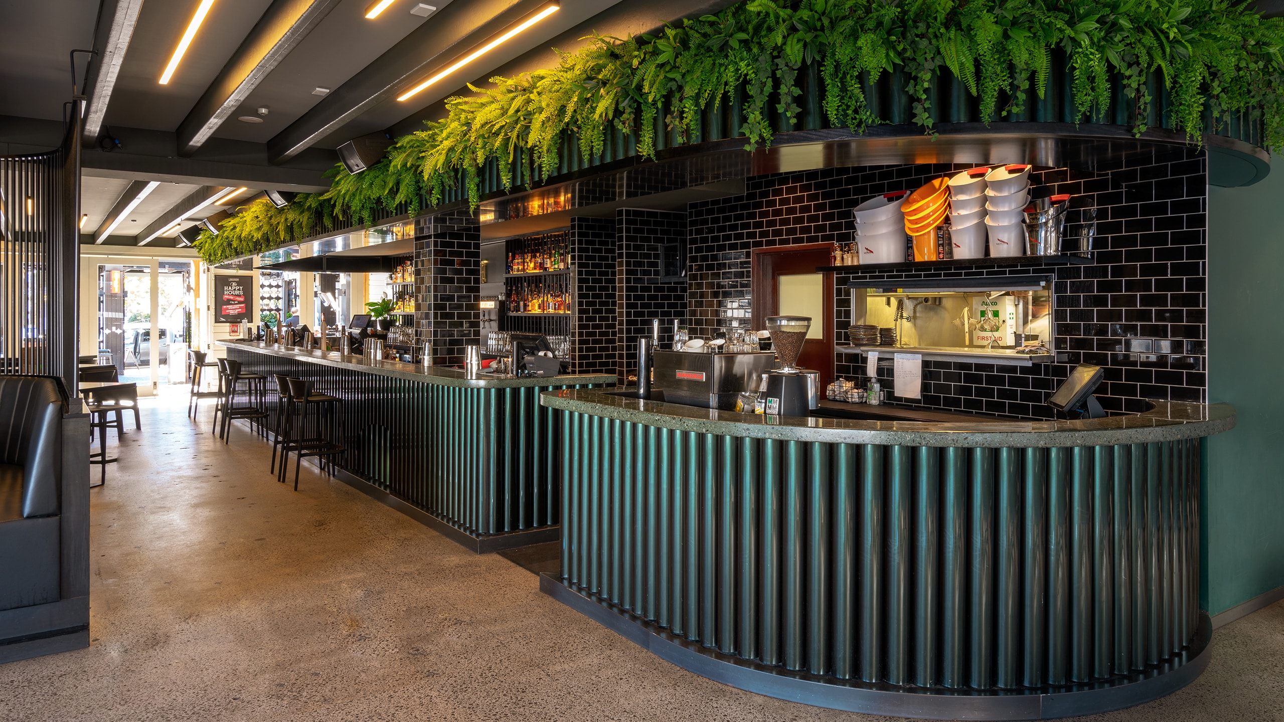 custom colour green, longroom, concrete bar and counter, full bar custom coloured concrete bar top.