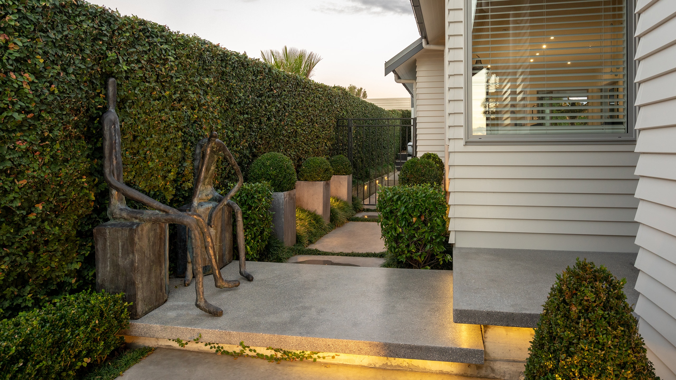 Coloured concrete path and hedge