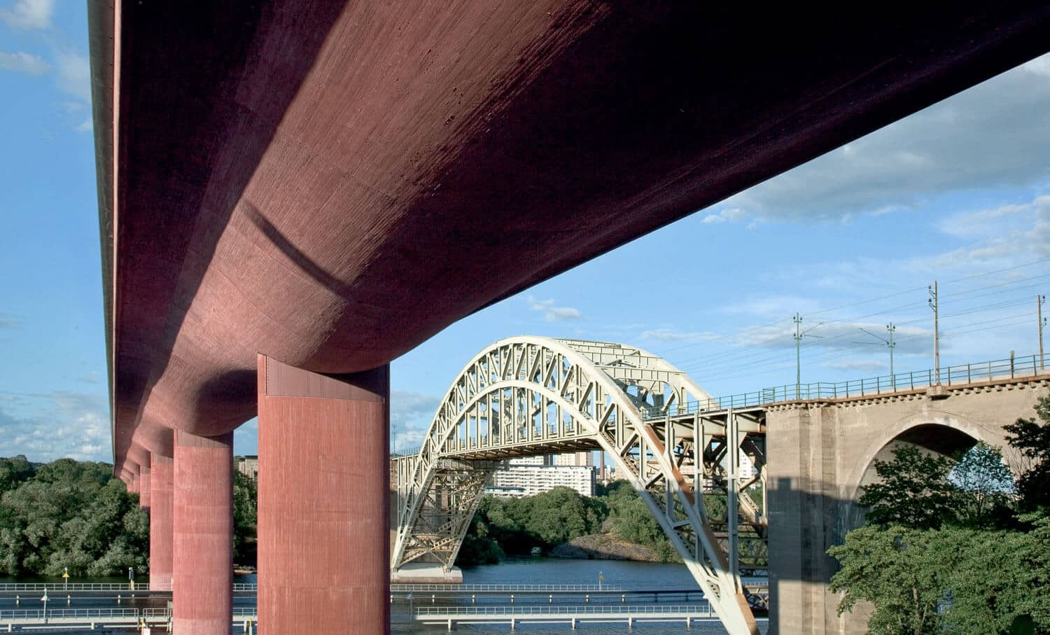 red-coloured-concrete-bridge-public-space the underside of a motorway bridge made of bright red coloured concrete.